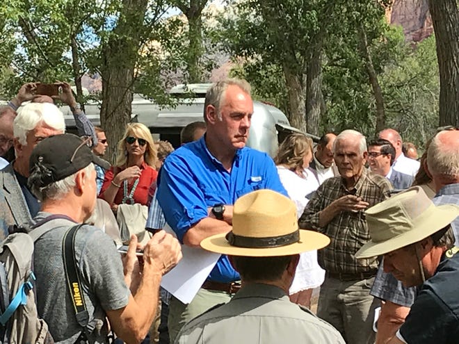 Interior Secretary Ryan Zinke hears from park officials during a visit to Zion National Park Sept. 24, 2018.