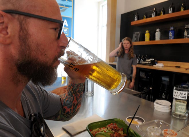 John Pierce drinks a beer with his lunch at Ventura Coast Brewing. The brewery  will will take part in the Wine & Food Experience put on by the Ventura County Star at the Camarillo Airport Hangar on Nov. 10.