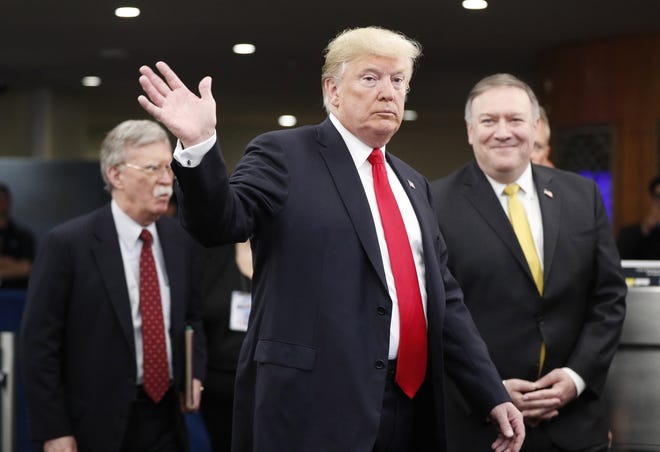 President Donald Trump arrives with Secretary of State Mike Pompeo, right, and National Security Advisor John Bolton, left, at the United Nations on Sept. 24, 2018. 
