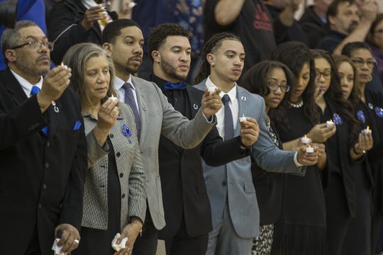 The family of late Indianapolis Colt Edwin Jackson, including father Wesley and mother Mary Ellen (left) hold candles during a vigil remembering Jackson and late Uber driver Jeffrey Monroe in Indianapolis last February.