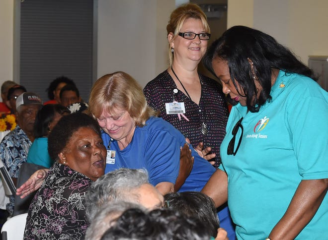 Theresa Stelly of LHC Group gives a hug to a senior citizen at Sunset's Seniors Helping Seniors event.