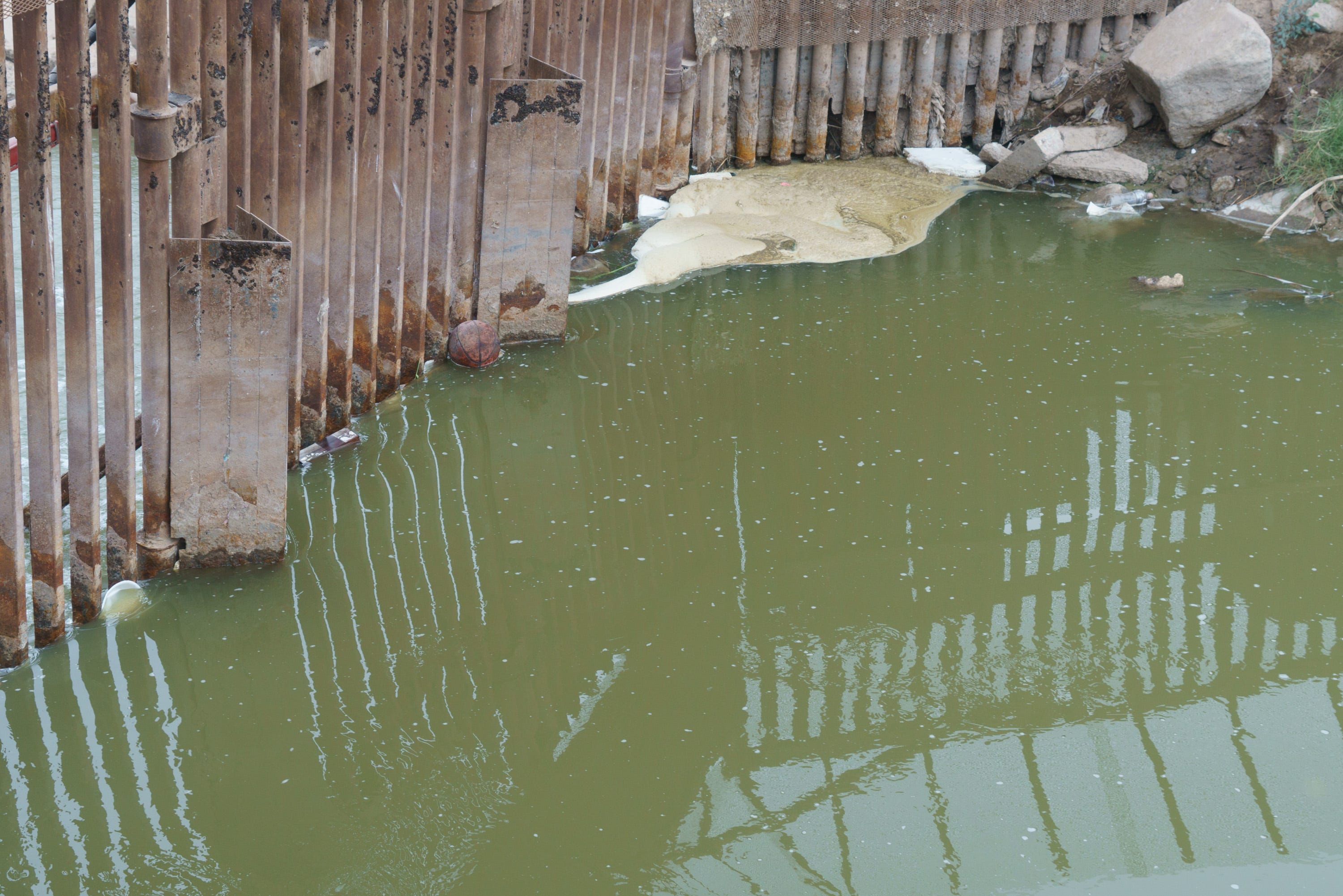 The New River flows through a gate north of the border in Calexico.