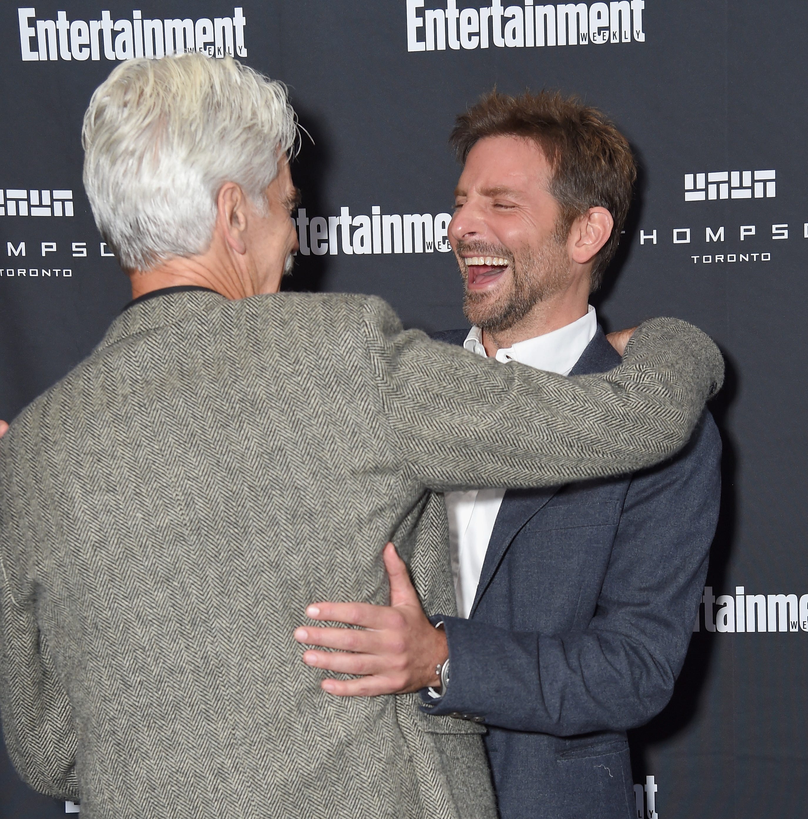 Sam Elliott, left, hugs 