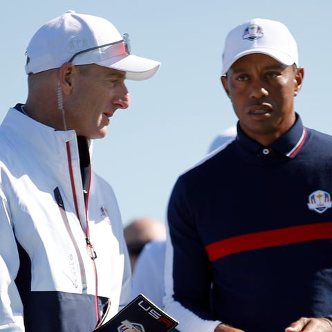 U.S. team captain Jim Furyk, left, stands with...