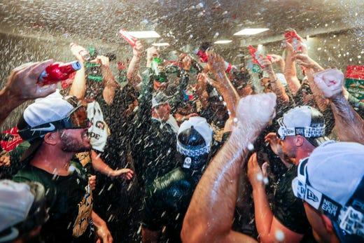 Sept. 24: The Oakland Athletics  celebrate following a 7-3 victory against the Seattle Mariners to clinch a wild card berth.