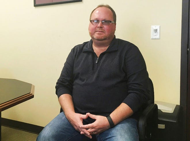 In this Nov. 9, 2017, file photo, Elwood Caudill Jr. sits at the Rowan County Property Valuation Administrators office in Morehead, Kentucky. Caudill won the Democratic nomination in May 2018 to face Republican Rowan County Clerk Kim Davis in the November election. Caudill defeated David Ermold, a gay man who was denied a marriage license by Davis in 2015.