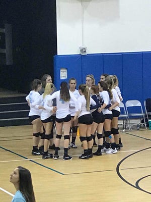 Marco Island coach Alyssa Stolinas chats with her team during a timeout during a recent match.