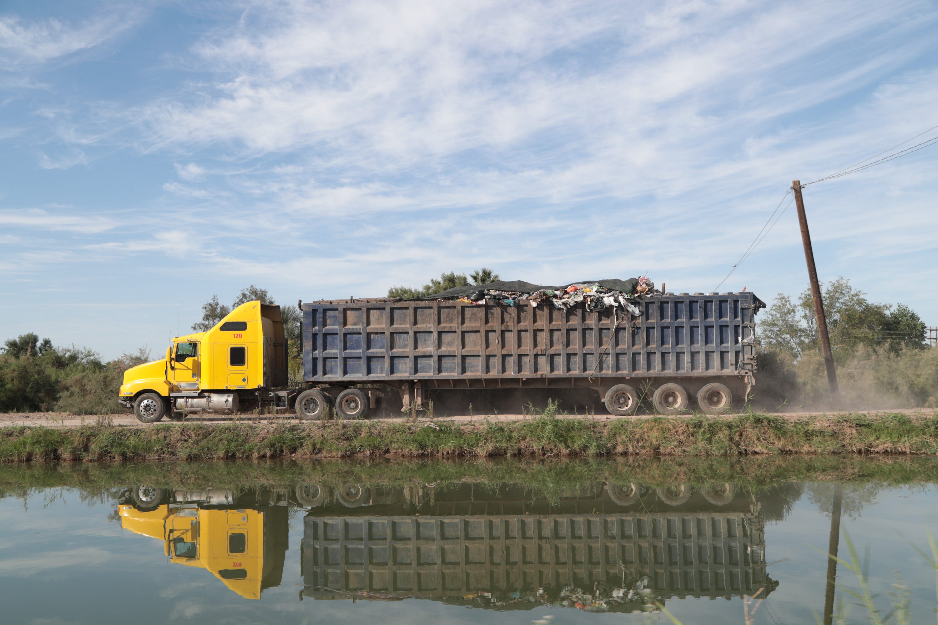 A truck drives along the Pacífico Canal toward a dump in the Mexicali Valley.