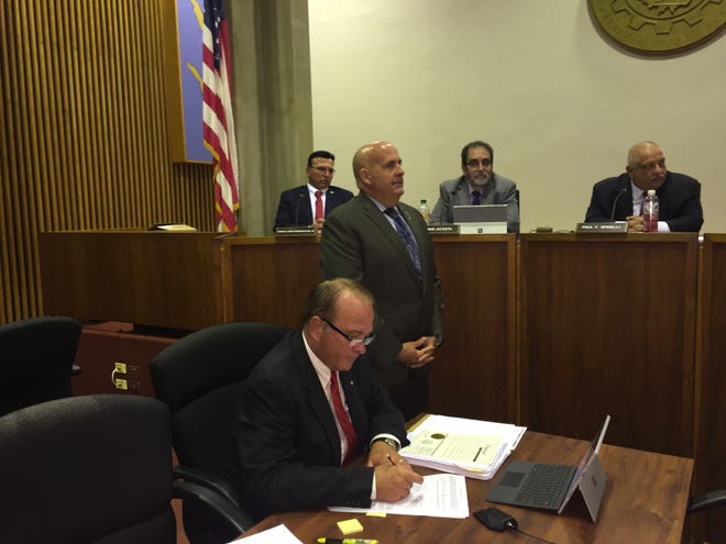 Recently retired Vineland police Capt. Matthew Finley stands next to City Clerk Keith Petrosky during a presentation at the City Council meeting on Tuesday night. In the background, left to right, are Councilman Ronald Franceschini Jr.,  Vice President David Acosta, and President Paul F. Spinelli.