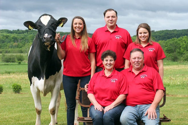Pam Selz-Pralle and her husband Scott Pralle (front) took over Humbird, Wsconsin, farm from Pam's dad in 1990. The farm is home to the current world record-holding Holstein cow, Selz-Pralle Aftershock 3918.