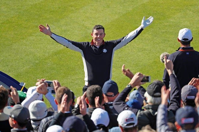 European golfer Rory McIlroy leads  fans in a cheer on the first tee during a Ryder Cup practice round at Le Golf National.