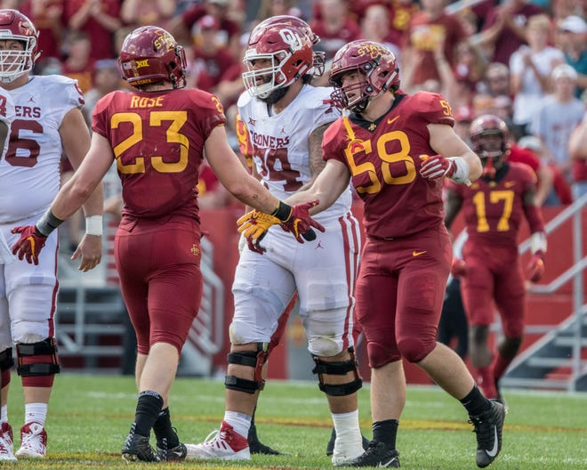 Iowa State's Spencer Benton, 58, and Mike Rose, 23 high five during a game against Oklahoma on Sept. 15, 2018.