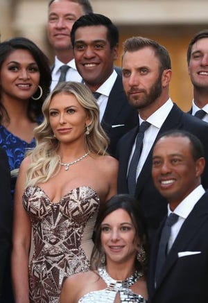 Dustin Johnson, top right, and his partner Paulina Gretzky, and Tiger Woods and his girlfriend Erica Herman before the Ryder Cup Gala dinner.
