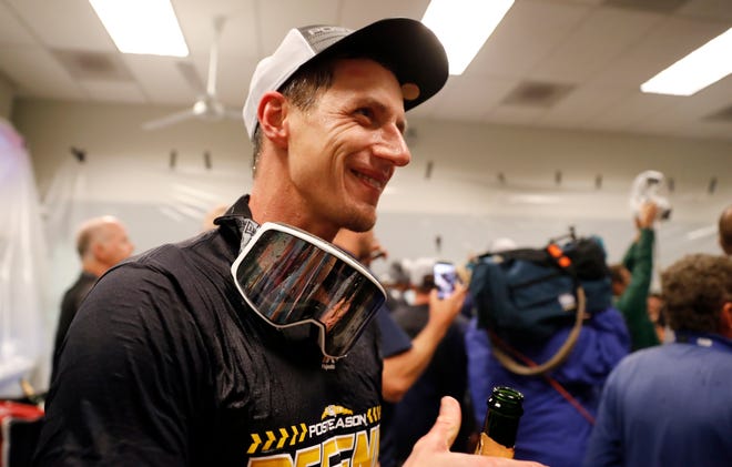 Brewers manager Craig Counsell celebrates with his team.