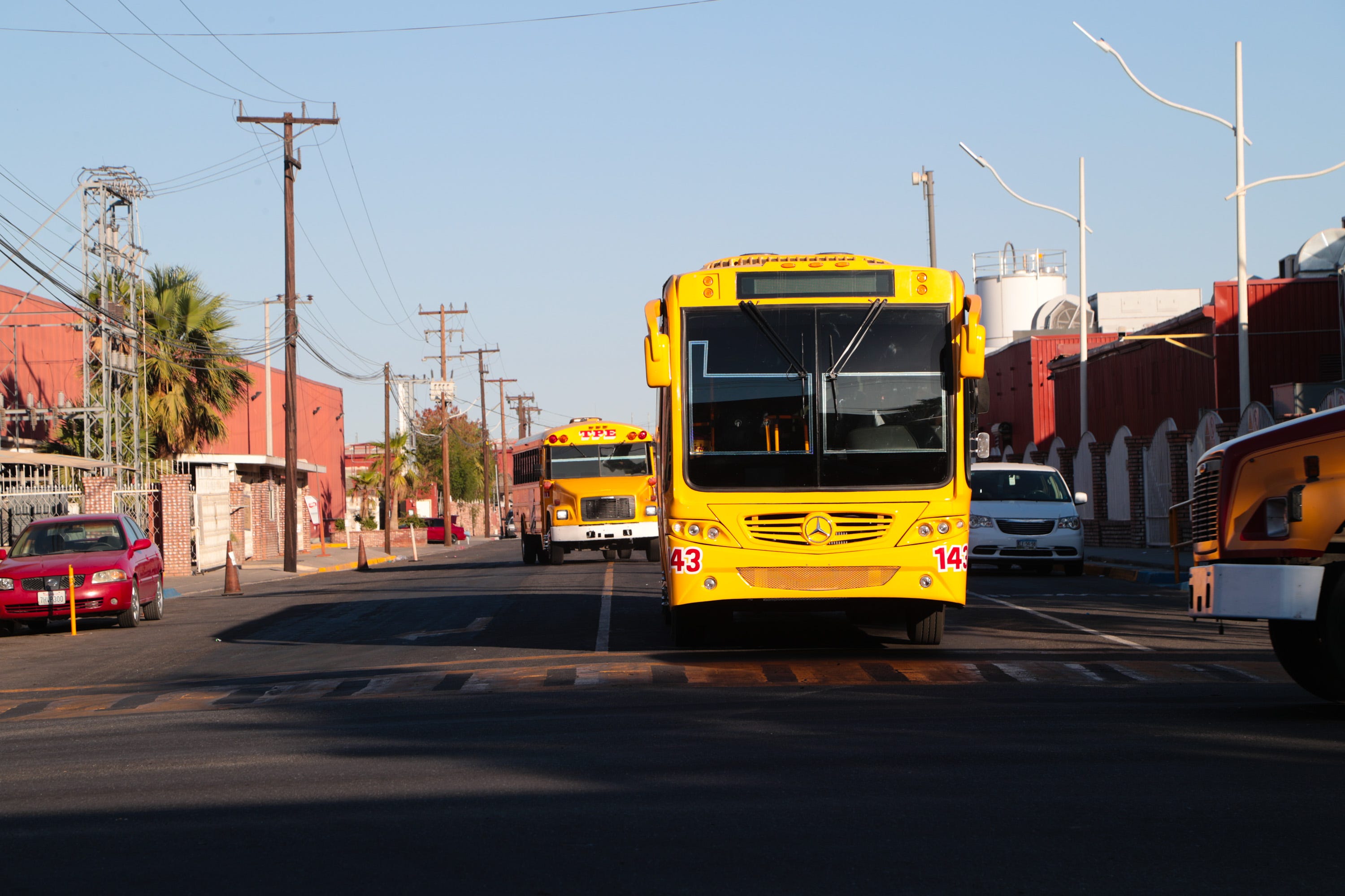 Buses leave the Maran Industrial Park in Mexicali on June 21, 2018.