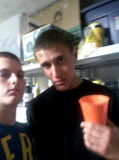Michael Mandell (left) and Tyler Hadley pose for a picture taken on a cell phone during the party held at Hadley's house after he killed his parents on July 16, 2011.