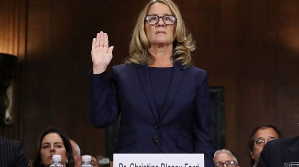Christine Blasey Ford is sworn in before the...