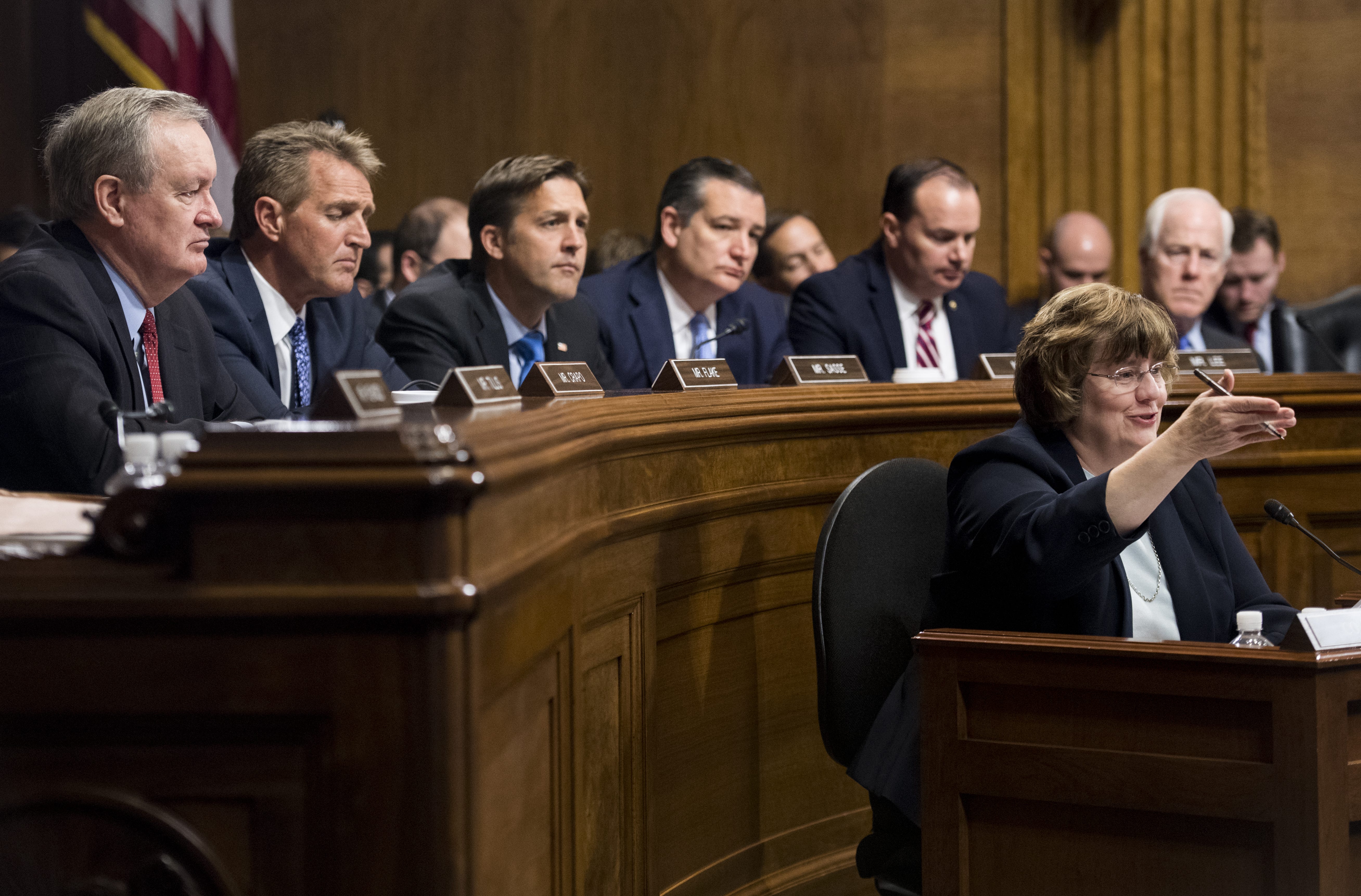 Rachel Mitchell, counsel for Senate Judiciary Committee Republicans, questions Christine Blasey Ford as senators, from left, Ben Sasse, R-Neb., Ted Cruz, R-Texas, Mike Lee, R-Utah.,  and John Cornyn, R-Texas, listen during the Senate Judiciary Committee hearing on Capitol Hill Sept. 27, 2018, in Washington, D.C.