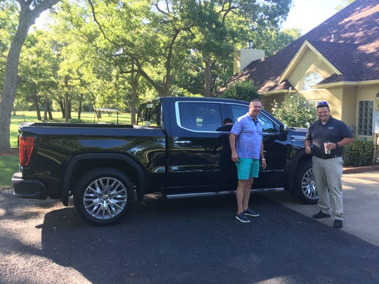 Mike Herron, left, with his 2019 GMC Sierra Denali and Gilchrist Automotive salesman David Bryson.