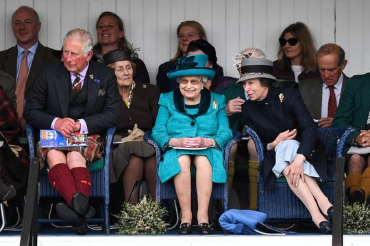 : Queen Elizabeth II, flanked by son Prince Charles and daughter Princess Anne, attend one of their favorite events, the annual Braemar Highland Gathering Highland Games on Sept.1, 2018 in Braemar, Scotland.