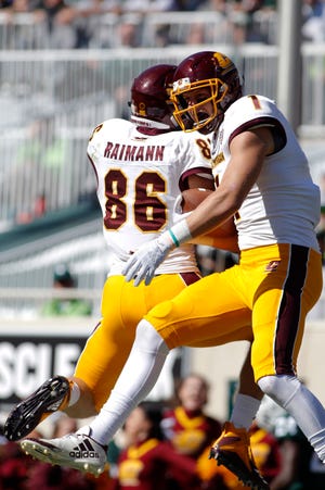 Central Michigan's Tony Poljan, right, and Bernhard Raimann (86) celebrate Poljan's touchdown reception against Michigan State during the fourth quarter of an NCAA college football game, Saturday, Sept. 29, 2018, in East Lansing, Mich. Michigan State won 31-20.