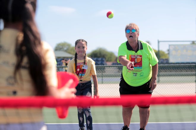 Rosie Casals, former professional tennis player and International Tennis Hall of Fame inductee, instructs Esmeralda Quintero, 9, on the basics of tennis at the Indian Wells Tennis Garden on Saturday, September 29, 2018 in Indian Wells during the Rosie Casals & Pancho Gonzalez Kids Tennis Fiesta. 120 third and fourth graders from the Coachella Valley Unified School District Expanded Program attend the camp. The equipment was donated to them two years before by tennis legend Billie Jean King.