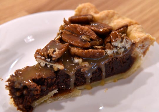 Kerry Hedges' sea salt chocolate pecan caramel pie Sept. 27, 2018. Slowpoke Farm Market features homemade pies, bread, and other foods.