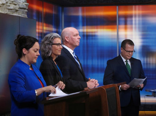 From left, Libertarian Elinor Swanson, Democrat Kathleen Williams and Republican U.S. Rep. Greg Gianforte listen to introductory remarks before a debate for Montana's U.S. House seat on Saturday, Sept. 29, 2018, in Helena, Mont. (AP Photo/Matt Volz)