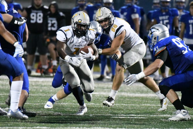 Marian running back Charles Salary (1) carries the ball against Saint Francis on Saturday night.