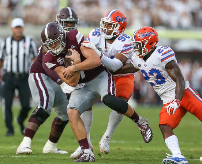 Mississippi State's Nick Fitzgerald (7) is tackled by Florida's Cece Jefferson (96) and Florida's Chauncey Gardner-Johnson (23) in the first quarter. Mississippi State and Florida played in an SEC college football game on Saturday, September 29, 2018, in Starkville. Photo by Keith Warren/Madatory Photo Credit