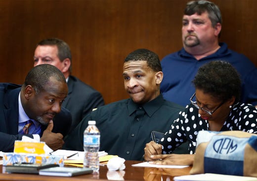 Defendant Quinton Tellis (middle) looks on as the jury goes to deliberate his case, as his defense attorneys Alton Peterson (left) and Darla Palmer (right) confer on the sixth day of his retrial in Batesville, Mississippi on Sunday, September 30, 2018. Tellis is charged with burning 19-year-old Jessica Chambers to death almost three years ago on Dec. 6, 2014. Tellis has pleaded not guilty to the murder.