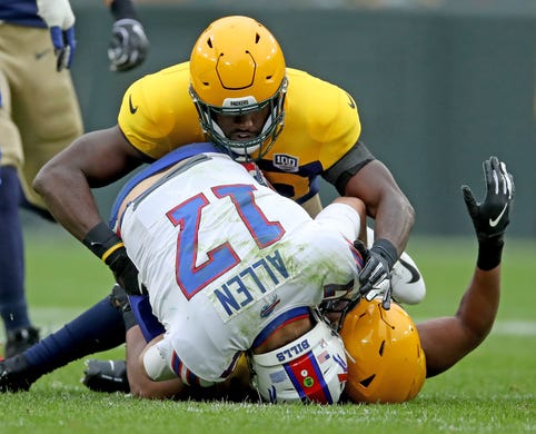 Green Bay Packers linebacker Reggie Gilbert (93) and linebacker Oren Burks (42) sack quarterback Josh Allen (17) against the Buffalo Bills Sunday September 30, 2018 at Lambeau Field in Green Bay, Wis.