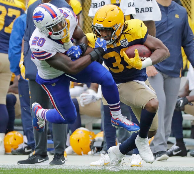 Green Bay Packers running back Aaron Jones (33) stiff arms Buffalo Bills defensive back Rafael Bush (20) in the first quarter at Lambeau Field on Sunday, September 30, 2018 in Green Bay, Wis.Adam Wesley/USA TODAY NETWORK-Wisconsin