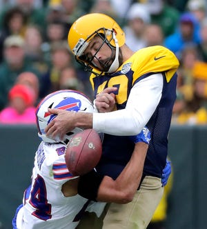 Green Bay Packers quarterback Aaron Rodgers fumbles as he is sacked by Buffalo Bills cornerback Taron Johnson in the second half on Sunday, September 30, 2018, at Lambeau Field in Green Bay, Wis.