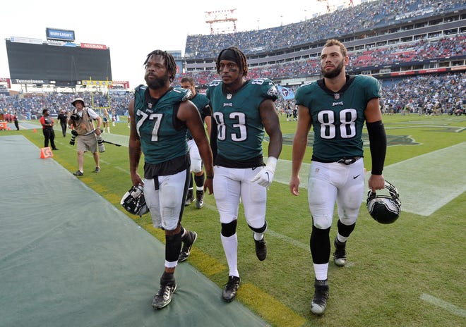 Philadelphia Eagles defensive end Michael Bennett (77), tight end Josh Perkins (83) and tight end Dallas Goedert (88) leave the field after losing to the Tennessee Titans in overtime of an NFL football game Sunday, Sept. 30, 2018, in Nashville, Tenn. The Titans won 26-23. (AP Photo/Mark Zaleski)