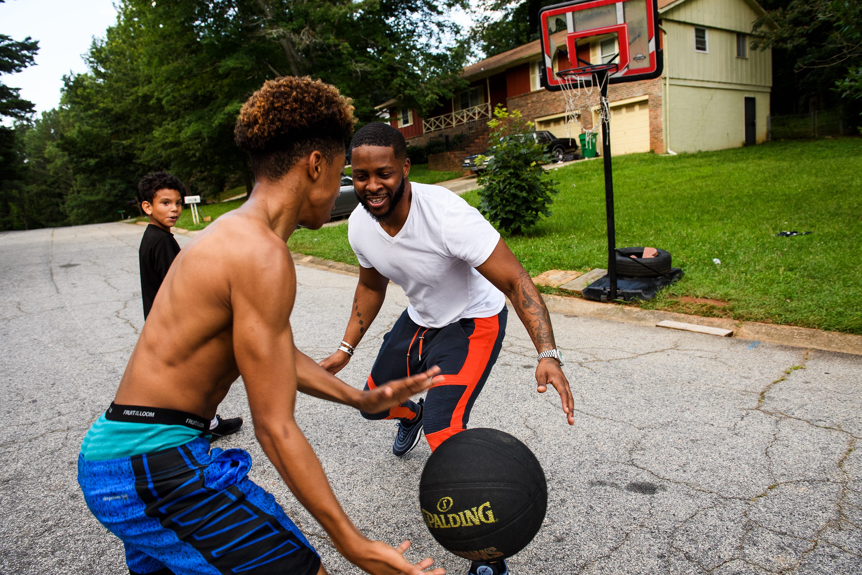 Johnnie Grant plays basketball with his son Da'Shawn and stepson Malachi on Saturday, June 30, 2018. A musician, Grant was headed to Charlotte for a performance when his rental car was pulled over in South Carolina.