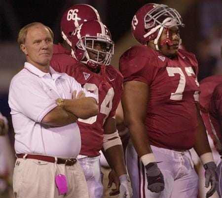 Former Alabama football coach Mike DuBose, left, shown in 2000, accidentally shot himself in the abdomen Monday.