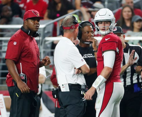 Arizona Cardinals quarterback Josh Rosen (3) talks with (from left) quarterbacks coach Byron Leftwich, offensive coordinator Mike McCoy and head coach Steve Wilks during a break against the Seattle Seahawks in the second quarter at State Farm Stadium in Glendale, Ariz. September 30, 2018.