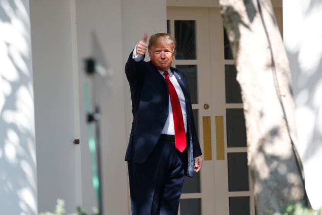 President Donald Trump gives a thumbs up to the media as he walks along the colonnade near the Rose Garden of the White House in Washington, Monday, Oct. 1, 2018.