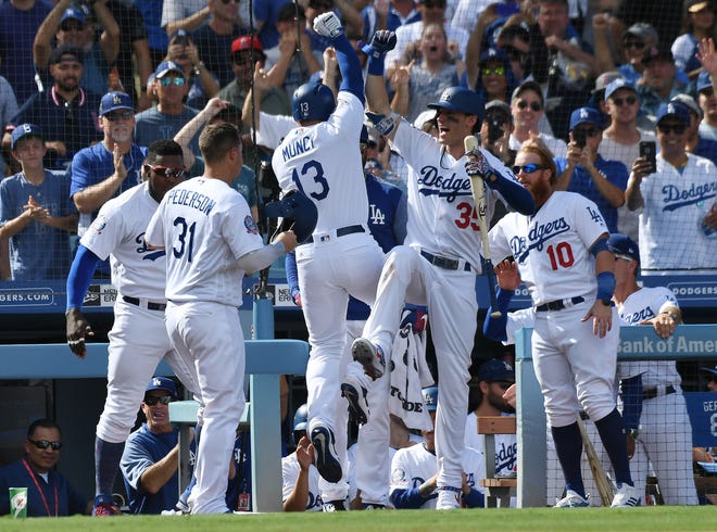 First baseman Max Muncy, left, and center fielder Cody Bellinger provided plenty of punch for the Dodgers in Monday's game. Each hit a two-run homer off Rockies starter German Marquez.