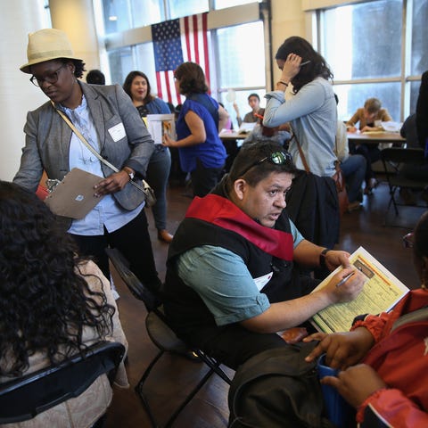 Volunteers assist immigrants with U.S....