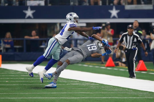 Detroit Lions receiver Kenny Golladay catches a pass as Dallas Cowboys cornerback Chidobe Awuzie defends in the second half in Arlington, Texas, Sunday, Sept. 30, 2018.