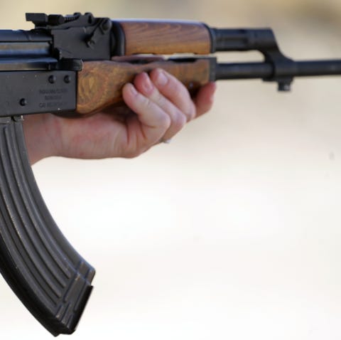 Pamela White grips her AK-47 style rifle as she...