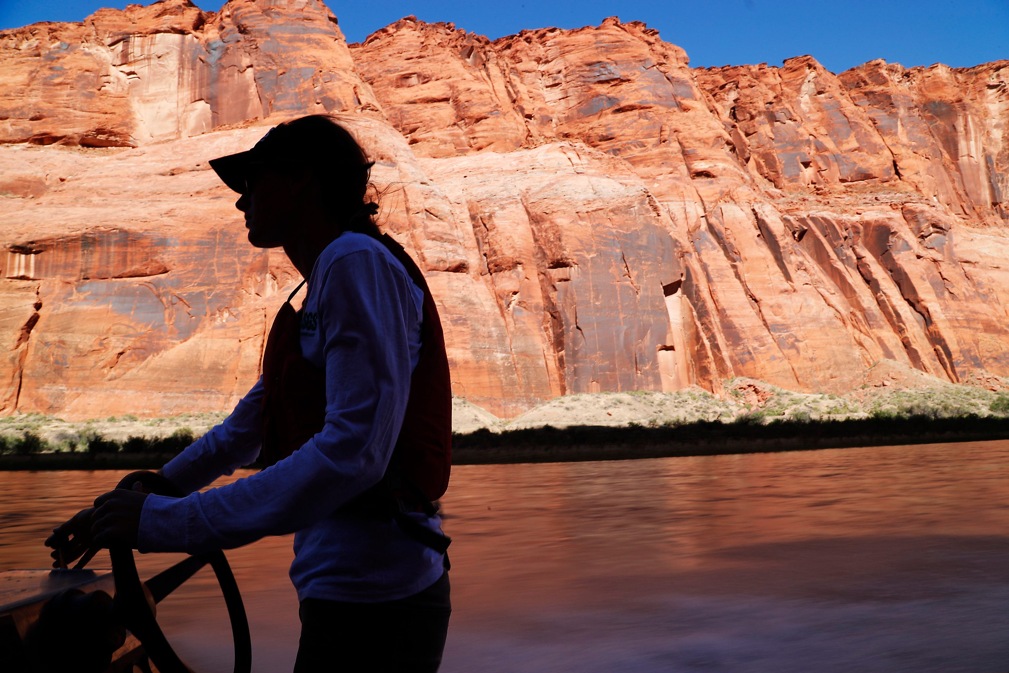 U.S. Geological Survey biologist Megan Daubert navigates the Colorado River while collecting bug traps near Marble Canyon. Experts say the river’s insect population offers less nourishment to go around than a healthy environment would provide.