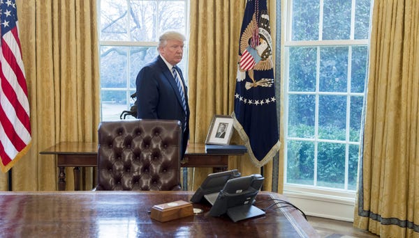 President Donald Trump with a photo of his...
