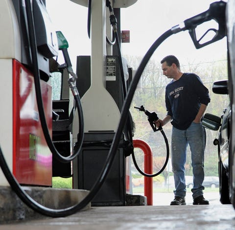 John Magel pumps gas at a station in...