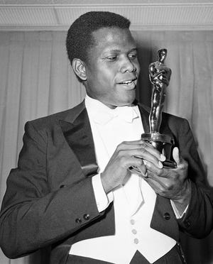 Actor Sidney Poitier is photographed with his Oscar statuette at the 36th Annual Academy Awards in Santa Monica, Calif. on April 13, 1964. He won best actor for his role in "Lilies of the Field."