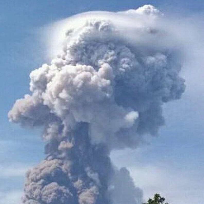 A handout photo made available by Indonesia's National Agency for Disaster Management shows Mount Soputan as it spews hot ash in Minahasa, North Sulawesi, Indonesia, on October 3, 2018.