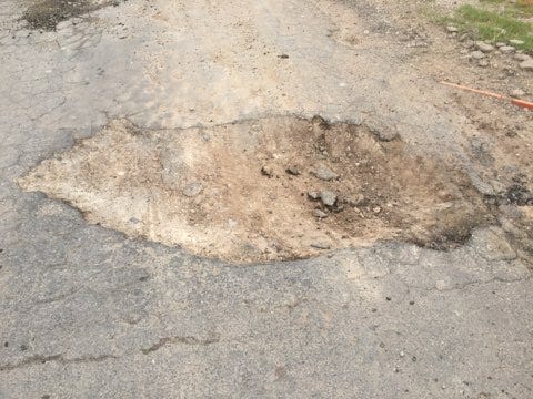 A massive pothole greets motorists on Black River Village Road.