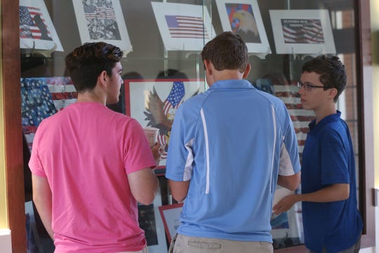 Maclay high school students marvel at their peers' work on display at the Tallahassee National Cemetery on October  4, 2018.